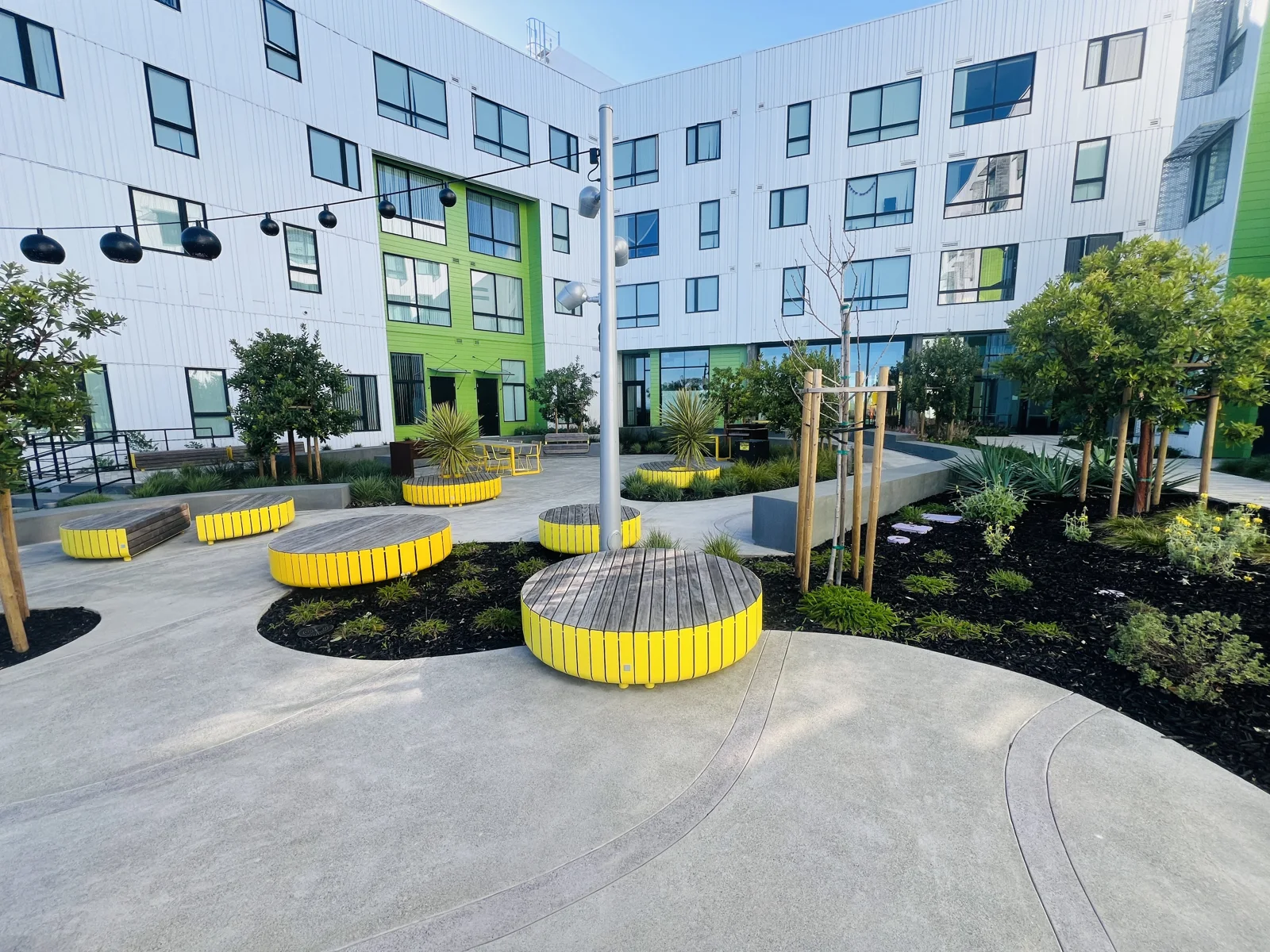 Landscaped multifamily courtyard with seating and shared outdoor space